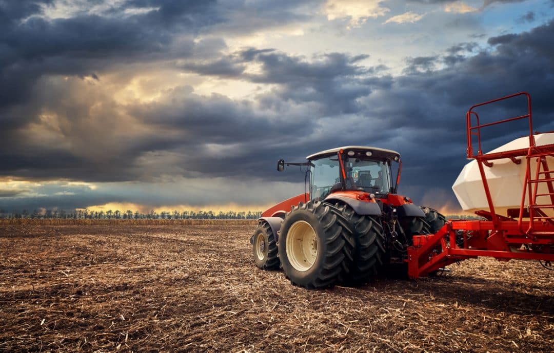 Tractor with agricultural implement in the field